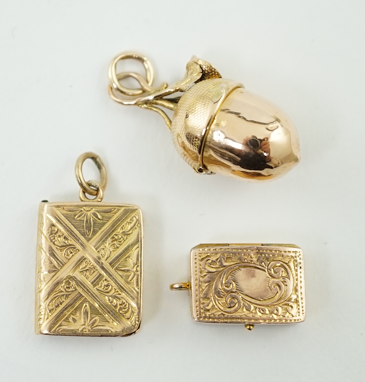 Three small gold vinaigrette charms